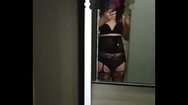 A transgender whore, embodying characteristics associated with labels such as shemale, tranny, crossdresser, tgirl, sissy, femboy, or ladyboy, she opens the restroom door, revealing her sensual figure.